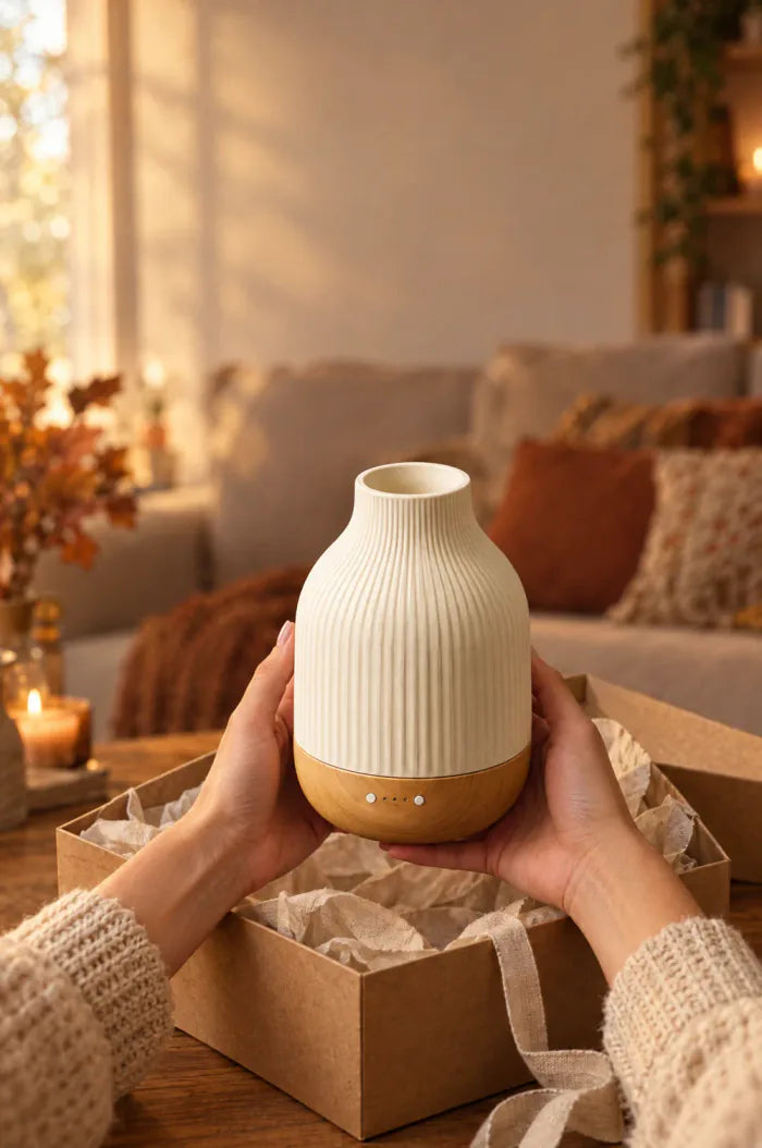 Hands lifting the ribbed ceramic diffuser out of its box