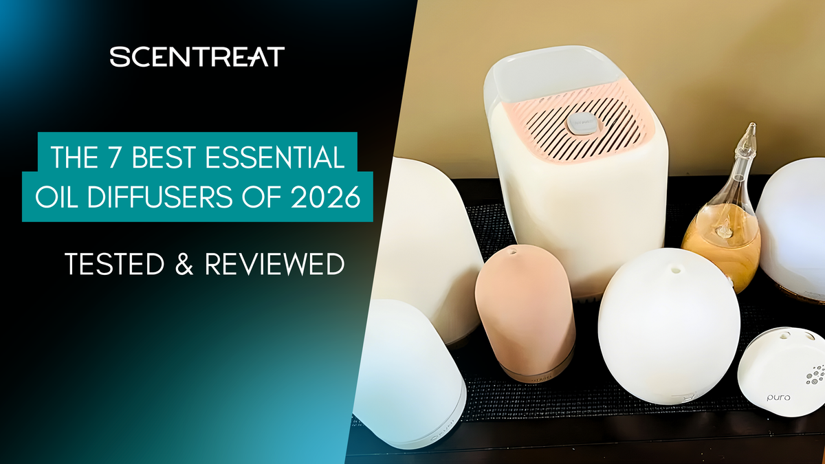A lineup of the best essential oil diffusers on a black mat, including white, pink, glass and Pura models