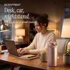 Mini diffuser on a desk beside a laptop