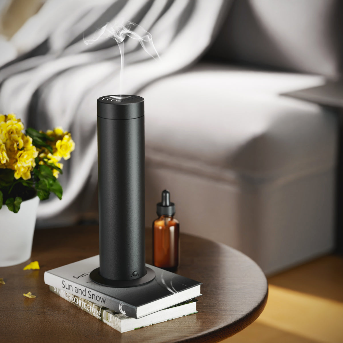 Black waterless essential oil diffuser in a living room