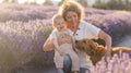 Woman holding a child and a dog in a lavender field