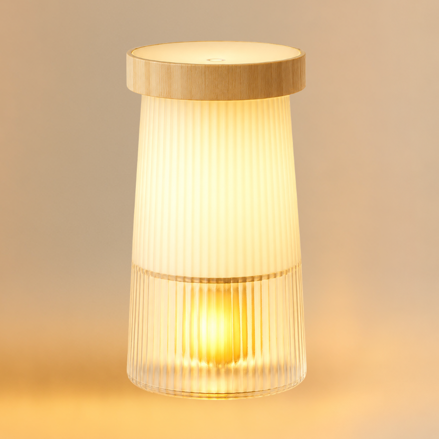 Scentreat waterless diffuser and night light with a fluted frosted glass body and wood lid glowing warm amber
