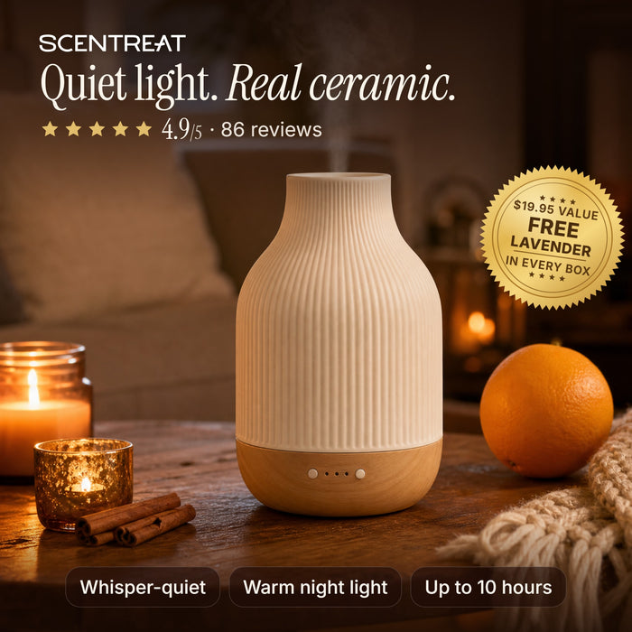 Ceramic essential oil diffuser glowing on a cozy living room table
