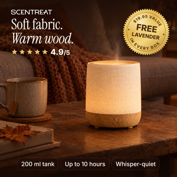 Wood essential oil diffuser with fabric cover glowing in a cozy living room
