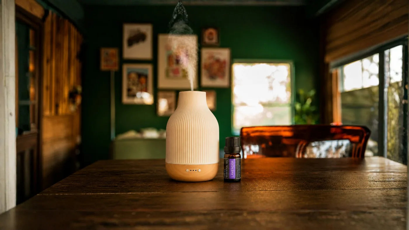 Ceramic diffuser misting on a table in a calm green living room